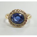 An 18ct, synthetic? sapphire and rose cut diamond set oval cluster ring, size M, gross weight 2.6