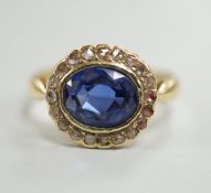An 18ct, synthetic? sapphire and rose cut diamond set oval cluster ring, size M, gross weight 2.6