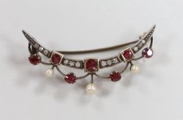 A late Victorian yellow metal, diamond, ruby and seed pearl set crescent brooch, 45mm, gross