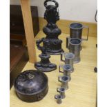 A graduated set of seven French pewter measures, a toleware spice box and two cast iron door