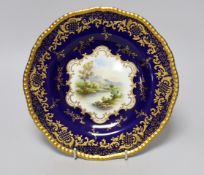 A Coalport gadroon-rimmed plate with elaborated blue and gilt border, painted with a central