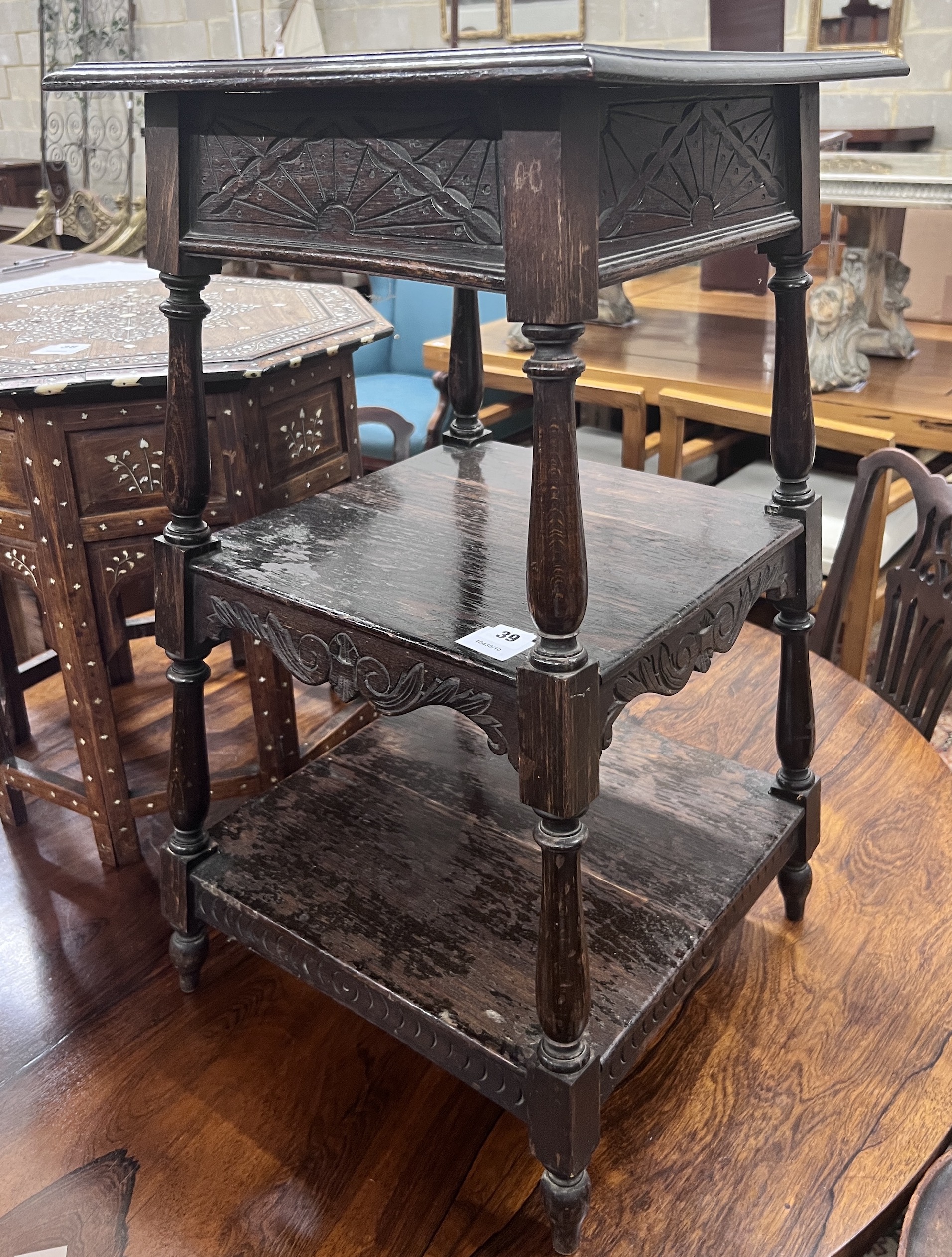 An early 20th century oak three tier occasional table, width 41cm, height 75cm