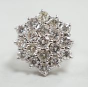 An 18ct white metal and diamond set hexagonal cluster ring, size L, gross weight 6.3 grams.