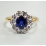 A modern 18ct gold, sapphire and diamond set circular cluster ring, size P/Q, gross weight 3.4