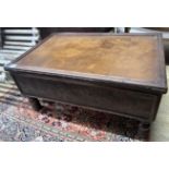 A rectangular embossed leather covered mahogany coffee table on turned feet, incorporates old