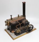 A vintage Stuart Turner model steam engine and boiler mounted on a wooden base, with booklet 33cm