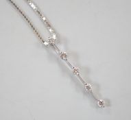 A modern 750 white metal and five stone diamond chip set line pendant, 25mm, on an 18kt white