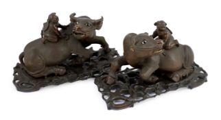 A pair of large Chinese carved hardwood buffalo groups, early 20th century, each well carved with
