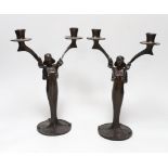 After Jules Moigniez (1835-1984) - a pair of bronze two branch candelabra, signed, dated 1902,