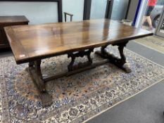 A 17th century style Italian design walnut refectory dining table, with carved angel head underframe