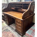 An early 20th century walnut roll top desk with 'S' shaped tambour, width 152cm, depth 84cm,