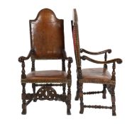 A pair of late 17th century Spanish walnut and elm armchairs, with arched leather covered backs,
