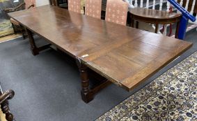 An 18th century style rectangular oak extending refectory dining table, length 342cm extended with