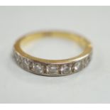 An 18ct and nine stone diamond set half eternity ring, size M, gross weight 3.5 grams.