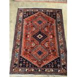 A Caucasian red ground rug, 144 x 105cm