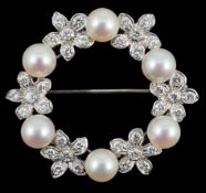 A late 20th century white gold cultured pearl and diamond cluster set openwork circular brooch, with