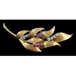 A 1960's 18ct gold, six stone ruby and seven stone diamond chip set leaf spray brooch, 55mm, gross