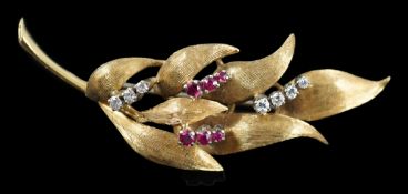 A 1960's 18ct gold, six stone ruby and seven stone diamond chip set leaf spray brooch, 55mm, gross