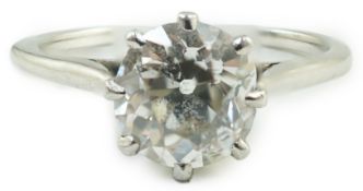 A platinum and solitaire diamond set ring, the round cut stone weighing approximately 1.30ct, size