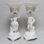 A pair of Paris porcelain figural comports or centre pieces with lattice work baskets, each 38cm