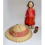 A composition Burmese doll, 40cm, related hat and a shoe