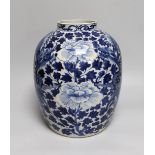 A large Chinese blue and white jar painted with a dragon amongst leaves and flowers, 29cm high