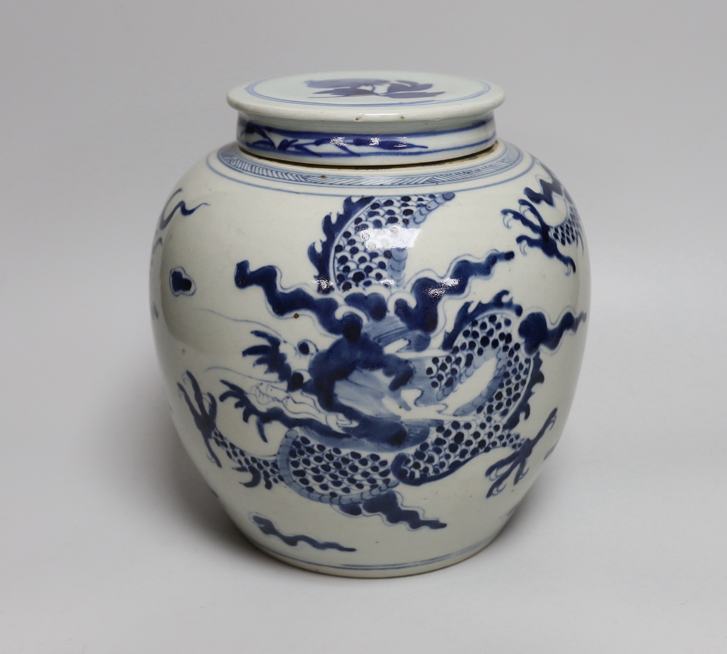 An 18th/19th century Chinese blue and white ‘dragon’ jar, with associated cover, jar 20.5cm high
