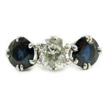 A white gold, sapphire and diamond set three stone ring, central stone approximately 1.4ct the