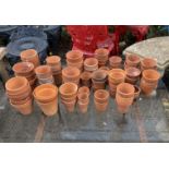 A quantity of assorted small terracotta plant pots