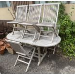 A weathered teak extending garden table, length 178cm, depth 89cm, height 75cm and six folding