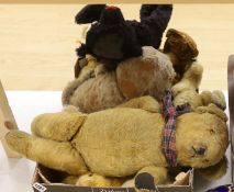 A collection of vintage and later teddy bears, some with articulated limbs, including a modern