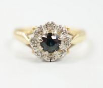 A 1960's 18ct gold, sapphire and diamond chip set cluster ring, size M, gross weight 4.9 grams.