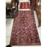 An antique Bokhara rug and one other, larger 160cm x 90cm.