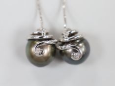 A modern pair of 750 white metal and diamond cultured set black pearl drop earrings, approx. 45mm,