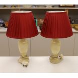 A pair of shaped alabaster table lamps, with shades, each 50cm high