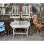 A weathered teak garden table, length 121cm, depth 89cm, height 75cm, and four folding elbow chairs