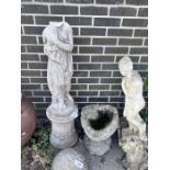 A reconstituted stone garden ornament of a robed lady, head detached, and a stone birdbath,