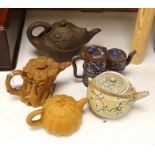 Four Chinese Yixing teapots and a Japanese sharkskin glazed teapot. Provenance - from a collection