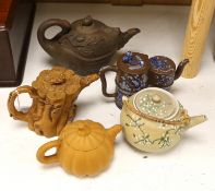 Four Chinese Yixing teapots and a Japanese sharkskin glazed teapot. Provenance - from a collection