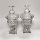 A pair of early Victorian cut glass pomade jars and covers, 30cm