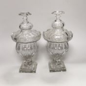 A pair of early Victorian cut glass pomade jars and covers, 30cm