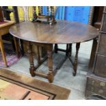 An 18th century style oak gateleg dining table, 140cm extended, depth 120cm, height 73cm