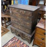 An 18th century oak chest on stand, width 102cm, depth 57cm, height 126cm