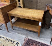 A mid century teak two tier table with hinged swivel top, width 83cm, depth 52cm, height 57cm