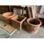 Three large square and circular terracotta garden planters, largest diameter 58cm, height 42cm