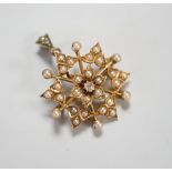 A late Victorian yellow metal (stamped 15), diamond and split pearl cluster set foliate pendant