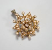 A late Victorian yellow metal (stamped 15), diamond and split pearl cluster set foliate pendant