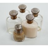 A set of four George V silver mounted glass scent bottles by Goldsmiths & Silversmiths Co Ltd,