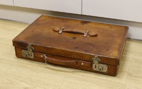 An early 20th century Hardy Bros. Alnwick tan leather fishing reel case, 58cm max.