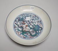 A Chinese doucai dish hand painted with a dragon chasing the flaming pearl, housed in a fitted case,